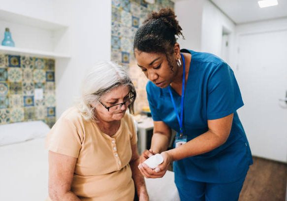 Nurse explaining to senior woman how to take her medicine at home